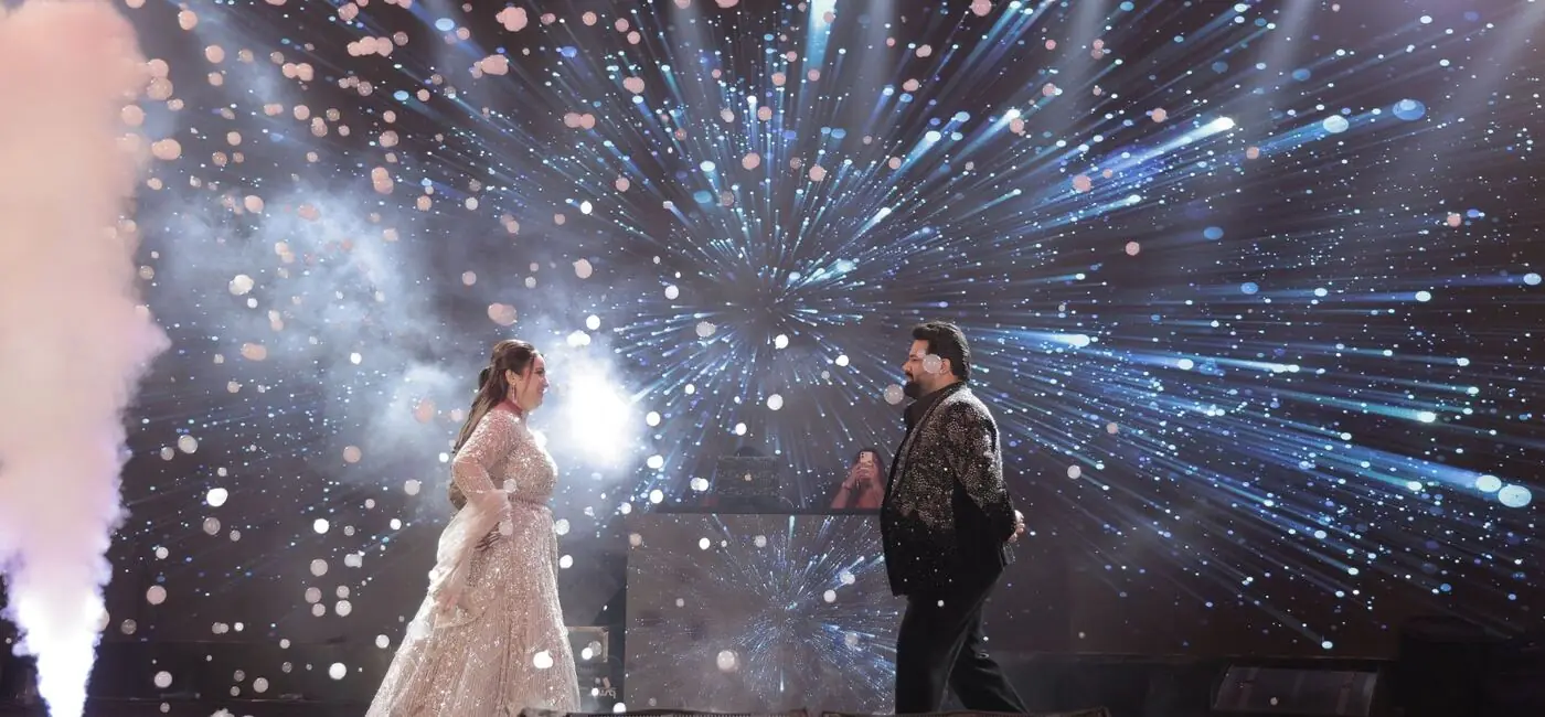 Couple's stage entry with confetti and LED wall
